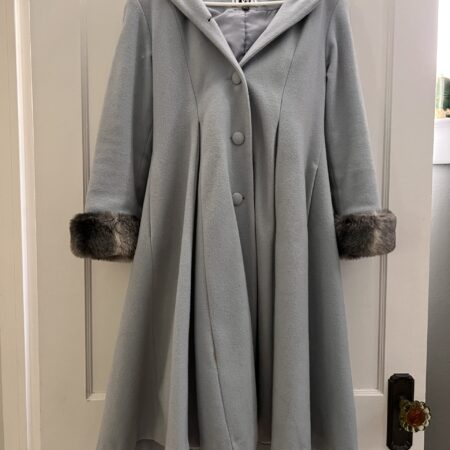 Baby blue winter coat with gray fur lining around cuffs and hood